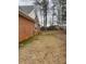 Residential backyard with brick home and mature trees at 11564 Holly Ln, Hampton, GA 30228