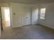 Well-lit bedroom with carpet, double doors, and view of hallway at 11564 Holly Ln, Hampton, GA 30228