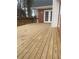 Wooden deck overlooks backyard, adjacent to home's exterior at 11564 Holly Ln, Hampton, GA 30228