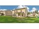 Exterior of home with a large backyard, covered patio, and neighboring houses at 405 Westmarch Cir, Loganville, GA 30052
