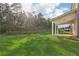 Wide backyard with covered patio and tree line at 405 Westmarch Cir, Loganville, GA 30052