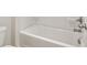 Bright white bathroom featuring a clean bathtub with silver fixtures and a toilet at 405 Westmarch Cir, Loganville, GA 30052