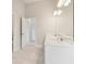 Bright bathroom features a double vanity with white cabinets and modern lighting at 405 Westmarch Cir, Loganville, GA 30052