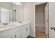 This bathroom includes a double sink vanity with white cabinets and a private toilet room at 405 Westmarch Cir, Loganville, GA 30052