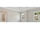 A view of bedroom featuring tray ceilings and exterior views at 405 Westmarch Cir, Loganville, GA 30052