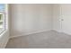 Bedroom with light gray walls, carpeted floors, a white door, and window at 405 Westmarch Cir, Loganville, GA 30052