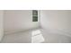 Bright bedroom features neutral carpet, paint, and a large window at 405 Westmarch Cir, Loganville, GA 30052