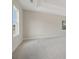 A spacious bedroom with neutral walls, soft carpet, and natural lighting at 405 Westmarch Cir, Loganville, GA 30052