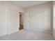 Bedroom with light gray walls, carpeted floors, white door, and a window at 405 Westmarch Cir, Loganville, GA 30052