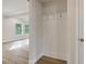 Hallway features a coat nook with hooks and wood-look floors with a view into the living room at 405 Westmarch Cir, Loganville, GA 30052