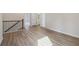 Hallway featuring hard wood flooring, dark handrail and iron railing at 405 Westmarch Cir, Loganville, GA 30052