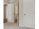 Hallway featuring a double door entry into the bathroom and view into other rooms at 405 Westmarch Cir, Loganville, GA 30052
