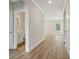 Hallway featuring hard wood flooring, light gray walls and white base boards at 405 Westmarch Cir, Loganville, GA 30052