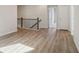 Hallway featuring hard wood flooring, dark handrail and iron railing at 405 Westmarch Cir, Loganville, GA 30052