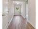 Inviting hallway with neutral walls, light wood floors and white trim at 405 Westmarch Cir, Loganville, GA 30052