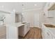 Bright kitchen featuring a kitchen island, stainless steel faucet and pendant lighting at 405 Westmarch Cir, Loganville, GA 30052