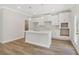 Bright, modern kitchen with island, white cabinets, stainless steel faucet, tiled backsplash and pendant lighting at 405 Westmarch Cir, Loganville, GA 30052