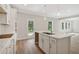 Bright, modern kitchen with island sink, stainless steel faucet, and open floor plan at 405 Westmarch Cir, Loganville, GA 30052