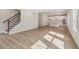 Large living space with staircase open to a bright kitchen with island and modern appliances at 405 Westmarch Cir, Loganville, GA 30052