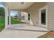 Covered patio overlooking the backyard with a grassy area and large pine trees at 405 Westmarch Cir, Loganville, GA 30052