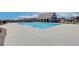 Community pool surrounded by a concrete pool deck, amenities building and other homes at 405 Westmarch Cir, Loganville, GA 30052