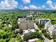 An aerial perspective showcasing the residential building amidst verdant greenery and the cityscape beyond at 2479 Peachtree Ne Rd # 407, Atlanta, GA 30305