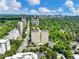 Expansive aerial view featuring the building and vibrant city skyline amidst lush greenery and blue skies at 2479 Peachtree Ne Rd # 407, Atlanta, GA 30305