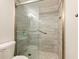 Modern bathroom features glass enclosed shower with gray and white tile at 2479 Peachtree Ne Rd # 407, Atlanta, GA 30305