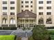 Attractive building entrance featuring a covered drop-off area, manicured landscaping, and convenient parking at 2479 Peachtree Ne Rd # 407, Atlanta, GA 30305