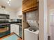 Compact kitchen with white cabinets and appliances, stacked washer and dryer included at 2479 Peachtree Ne Rd # 407, Atlanta, GA 30305