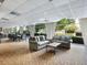 Comfortable lounge featuring sofas, a table, and dining space, all bathed in natural light from the expansive windows at 2479 Peachtree Ne Rd # 407, Atlanta, GA 30305
