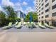 Inviting pool deck with lounge chairs, table, chairs, and umbrellas, perfect for relaxation and enjoyment at 2479 Peachtree Ne Rd # 407, Atlanta, GA 30305