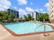 Community swimming pool surrounded by green trees and tall buildings on a sunny day at 2479 Peachtree Ne Rd # 407, Atlanta, GA 30305