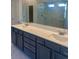 Bathroom with dual vanity featuring modern hardware and white countertop with sinks, alongside a marble shower at 407 Westmarch Cir, Loganville, GA 30052