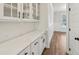 Butler's pantry with white cabinets, black hardware, and a quartz countertop, perfect for entertaining at 407 Westmarch Cir, Loganville, GA 30052