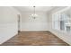 Elegant dining room featuring classic wainscoting, wood floors, and natural light at 407 Westmarch Cir, Loganville, GA 30052
