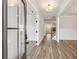 Bright entryway featuring hardwood floors, white trim, natural light, and staircase in view at 407 Westmarch Cir, Loganville, GA 30052