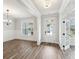 Inviting entryway featuring hardwood floors, white trim, natural light, and an adjacent dining room at 407 Westmarch Cir, Loganville, GA 30052