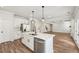 Bright kitchen featuring an island, stainless steel appliances, and modern white cabinetry at 407 Westmarch Cir, Loganville, GA 30052