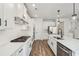 Stylish kitchen featuring white cabinets, stainless steel appliances and a gas cooktop at 407 Westmarch Cir, Loganville, GA 30052