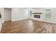 Bright living room featuring hardwood floors, a modern fireplace, and large windows at 407 Westmarch Cir, Loganville, GA 30052