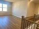 Open loft area with natural light and wood floors, perfect for flexible living at 407 Westmarch Cir, Loganville, GA 30052