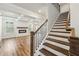 View of the staircase with hardwood floors leading up from the living room with fireplace at 407 Westmarch Cir, Loganville, GA 30052