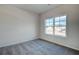 Bright bedroom features plush carpet, a window with neighborhood views at 414 Westmarch Cir, Loganville, GA 30052