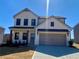 Beautiful two-story home with a two-car garage and neutral color scheme at 414 Westmarch Cir, Loganville, GA 30052