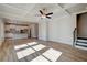 Bright, open-concept living space with hardwood floors and coffered ceiling at 414 Westmarch Cir, Loganville, GA 30052