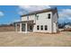 Rear exterior view of home showcasing covered patio and ample backyard space at 414 Westmarch Cir, Loganville, GA 30052