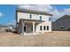 Back exterior of new home with covered porch and spacious yard at 414 Westmarch Cir, Loganville, GA 30052