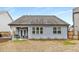 Home's back exterior featuring a covered patio and back deck with a fenced backyard at 505 Flyingbolt Run, Canton, GA 30115