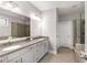 Bathroom featuring double sinks, a large mirror, white cabinets, and a glass door shower at 505 Flyingbolt Run, Canton, GA 30115